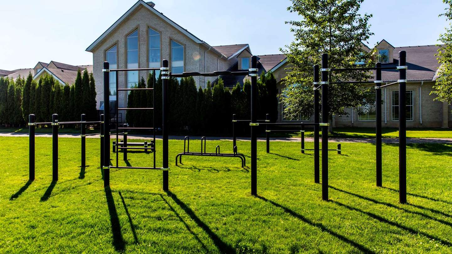 Reckstangen und Barren einer Calisthenics Anlage von KENGURU PRO im Garten einer Villa